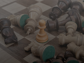 A pawn in the center of the board, with all the pieces around it fallen over.