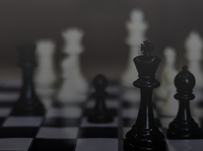 A dramatic shot of a black and white chess board showing an advanced position after starting with the Italian Opening